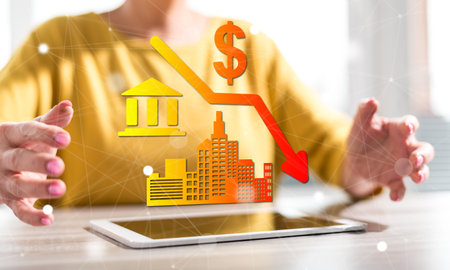 Digital tablet with economic crash concept between hands of a woman in background