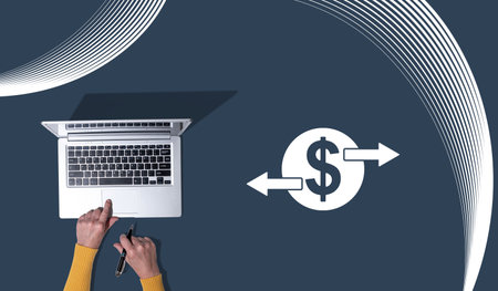 Top view of hands using laptop with symbol of money transfer concept