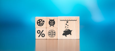 Wooden blocks with symbol of inflation concept on blue backgroundの写真素材