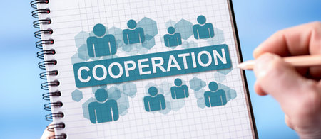 Hand drawing cooperation concept on a notepadの写真素材