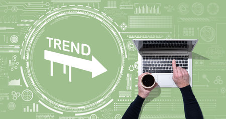 Top view of hands using laptop with symbol of trends conceptの写真素材