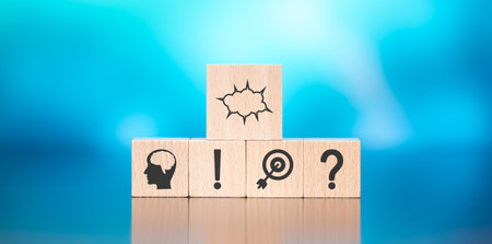 Wooden blocks with symbol of brainstorming concept on blue background