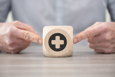 Wooden block with symbol of healthcare conceptの写真素材