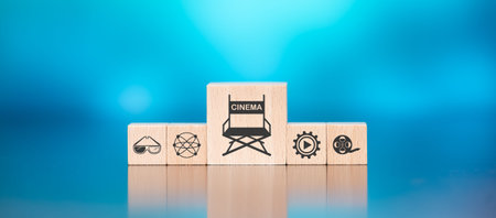 Wooden blocks with symbol of cinema concept on blue backgroundの写真素材