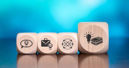 Wooden blocks with symbol of knowledge concept on blue backgroundの写真素材