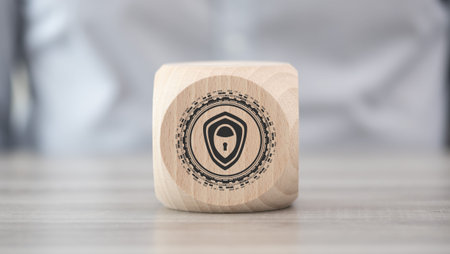 Wooden block with symbol of cybersecurity concept