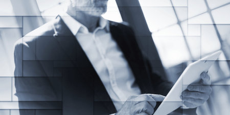 Senior businessman using tablet, hard light effect, geometric patternの写真素材