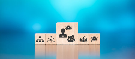 Wooden blocks with symbol of coaching concept on blue background