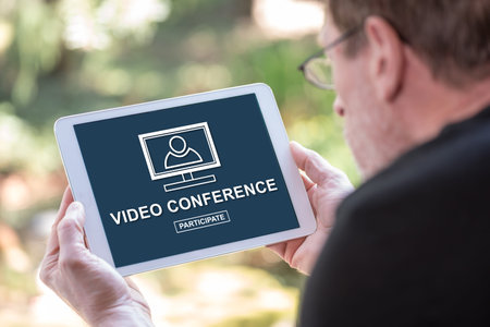 Tablet screen displaying a video conference conceptの写真素材