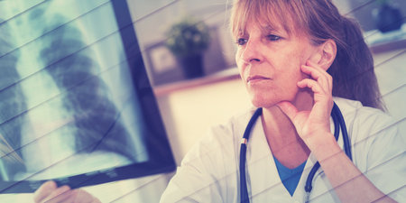 Female doctor looking at x-ray in medical office, geometric patternの写真素材
