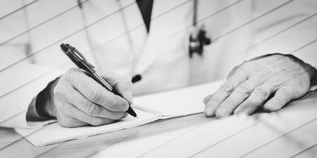 Doctor sitting at desk and taking notes, geometric patternの写真素材