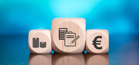 Wooden blocks with symbol of budget concept on blue backgroundの写真素材