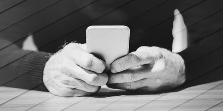 Male hand using mobile phone, geometric pattern