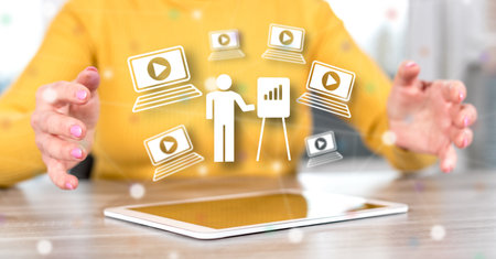 Digital tablet with webinar concept between hands of a woman in backgroundの写真素材