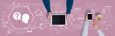Top view of hands using digital tablet and mobile phone with symbol of question concept