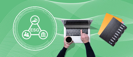 Top view of hands using laptop with symbol of esg concept