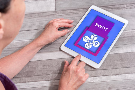 Woman using a tablet showing swot conceptの写真素材