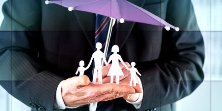 Concept of family insurance with umbrella protecting a family, geometric patternの写真素材