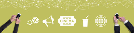 Top view of hands using mobile phone with symbol of cinema conceptの写真素材
