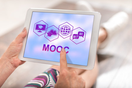 Woman using a tablet with mooc conceptの写真素材