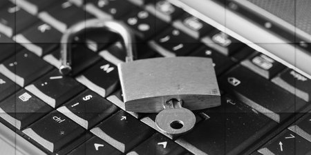 Computer security concept with a padlock on a keyboard, geometric patternの写真素材