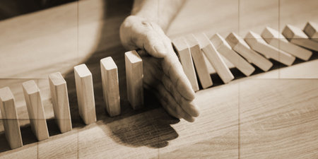 Business control concept by stopping domino effect, geometric pattern