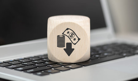 Wooden block with symbol of bankruptcy concept on laptop keyboard
