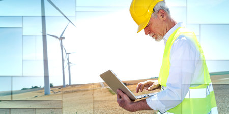 Electrical engineer using laptop for wind turbine inspection, geometric pattern