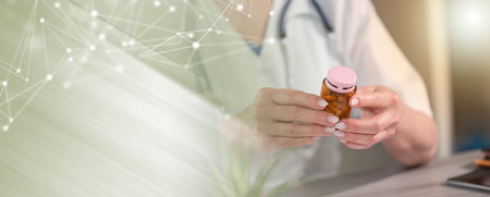 Female doctor looking at a bottle of pills in medical office; panoramic banner