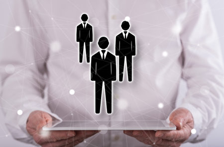 Business partner concept above a tablet held by a man in backgroundの写真素材