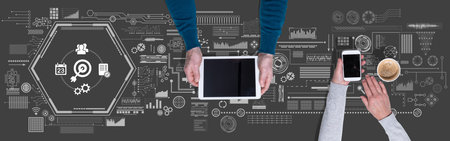 Top view of hands using digital tablet and mobile phone with symbol of action plan concept