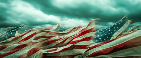 Waving american flags create a dramatic effect against a moody stormy sky backgroundの素材