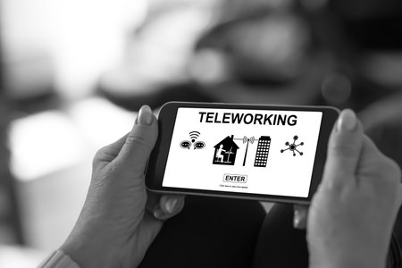 Smartphone screen displaying a teleworking conceptの写真素材