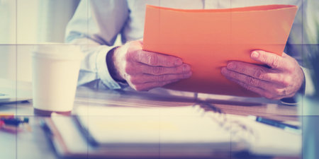 Businessman holding a folder at office, geometric patternの写真素材