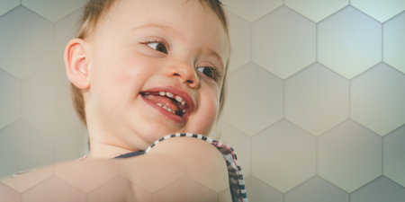 Portrait of happy cute baby girl with a beautiful smile, geometric patternの写真素材