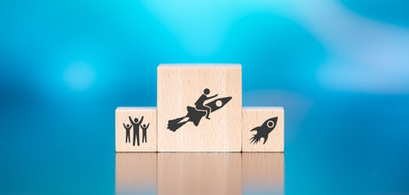 Wooden blocks with symbol of success concept on blue background