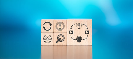 Wooden blocks with symbol of podcast concept on blue background