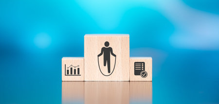 Wooden blocks with symbol of workout concept on blue backgroundの写真素材