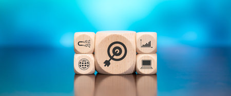 Wooden blocks with symbol of target marketing concept on blue backgroundの写真素材