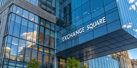 A contemporary glass facade of exchange square reflecting the sky and surrounding buildingsの素材