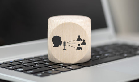 Wooden block with symbol of public relations concept on laptop keyboardの写真素材