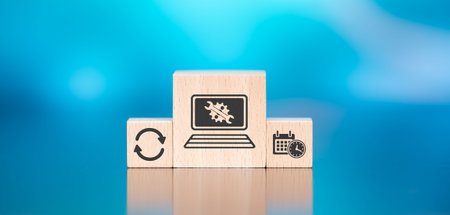 Wooden blocks with symbol of system maintenance concept on blue backgroundの写真素材