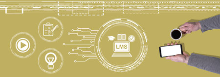 Top view of hands holding a mobile phone and a cup of coffee with symbol of lms conceptの写真素材