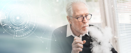 Portrait of senior man smoking electronic cigarette; panoramic bannerの写真素材