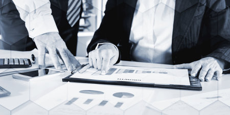 Business people in meeting talking about business performance, geometric pattern