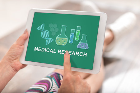 Woman using a tablet with medical research conceptの写真素材