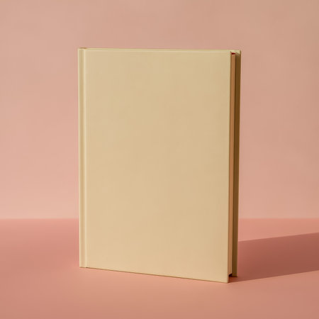 A minimalist closed book positioned against a soft pink background for aesthetic appealの素材