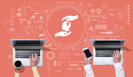 Top view of hands using laptop with symbol of intellectual property concept