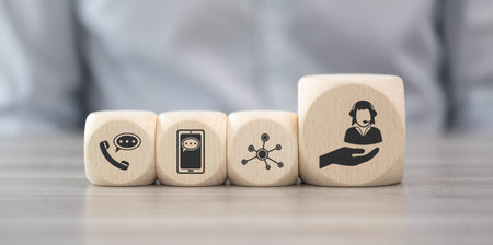 Wooden blocks with symbol of customer service conceptの写真素材