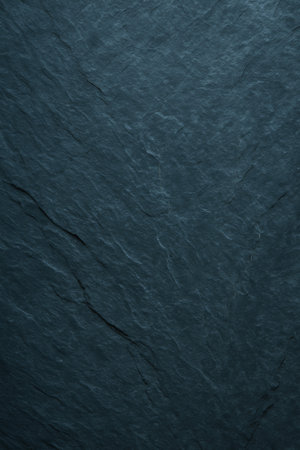 A close-up view of a dark slate surface showing natural patterns and texturesの素材